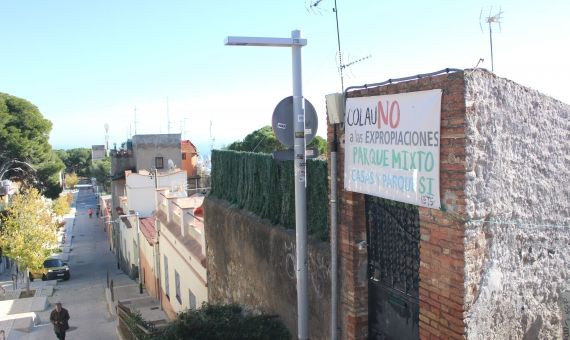 Un cartel en contra las expropiaciones colgado en la fachada de una de las casas en riesgo de derribo de la calle de Marià Labèrnia / AR