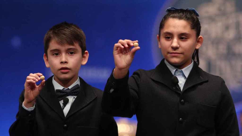 Dos de los niños de la residencia de San Idelfonso cantando el cuarto premio de la Lotería de Navidad