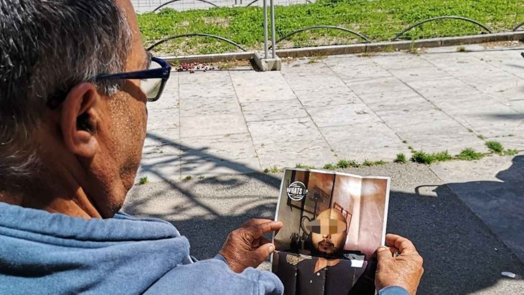 Un indigente mira la foto del presunto asesino / G A