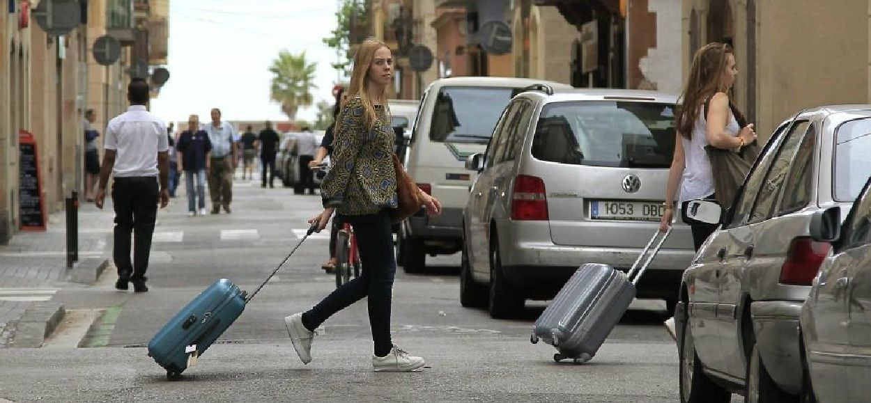 Dos jóvenes se dirigen a pisos turísticos en Barcelona / EFE