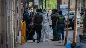 Agentes de la Guardia Civil totalmente protegidos salen de un domicilio de la calle de Josep Anselm Clavé en el distrito de Ciutat Vella de Barcelona donde detuvieron al presunto