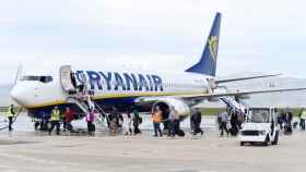 Dos decenas de pasajeros esperando para subir al vuelo de un avión de Ryanair / EFE