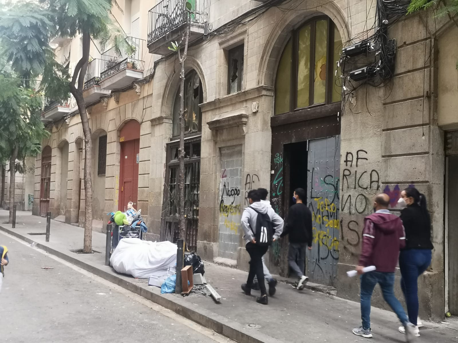 Varias personas pasan por delante de la 'narcofinca' de la calle Príncep de Viana este miércoles / GA