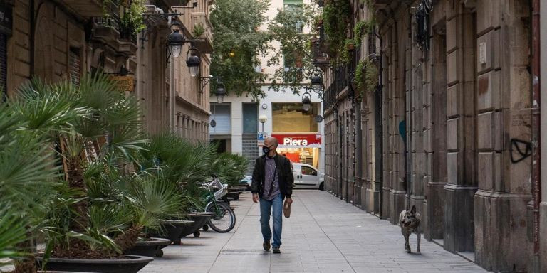 Un hombre camina por la calle Notariat / PABLO MIRANZO