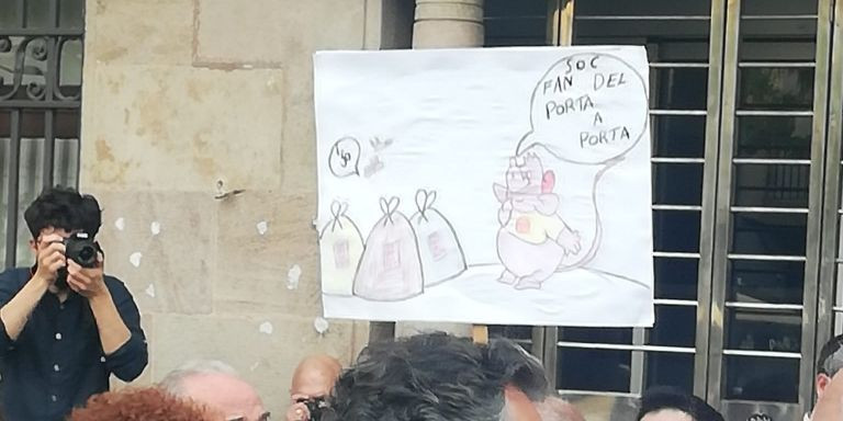 Pancarta de un vecino durante la manifestación. Se ve una rata que dice soy fan del puerta a puerta / METRÓPOLI