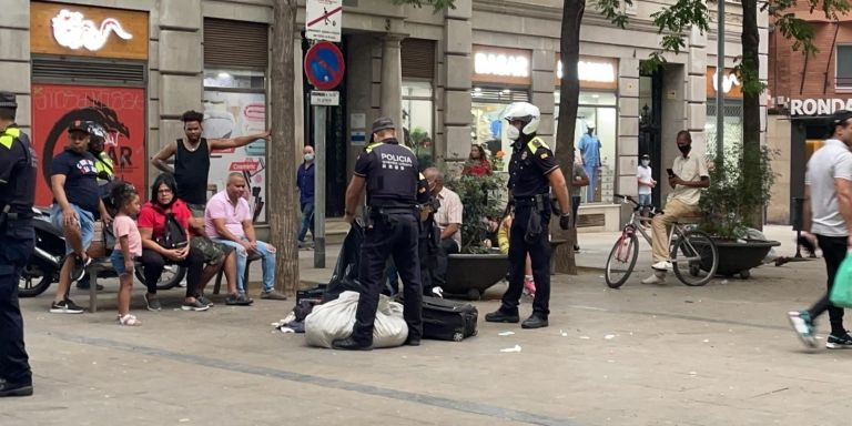 Agentes de la Guardia Urbana requisan material a la venta en el 'mercado de la miseria' este miércoles / METRÓPOLI