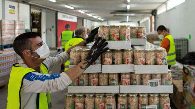 Varios voluntarios ordenan los pedidos de alimentos en el almacén del Banco de Alimentos de Barcelona / EFE