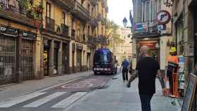 Un furgón policial circula en la calle de l'Hospital, donde han ocurrido los hechos, en el Raval / GUILLEM ANDRÉS