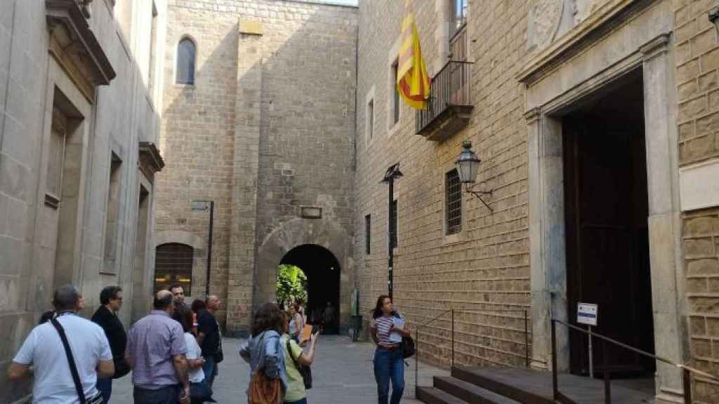 Un grupo de turistas admira la fachada del Institut d'Estudis Catalans (IEC)