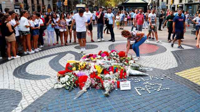 Flores depositadas por ciudadanos anónimos en el mosaico de Miró tras el atentado / EFE