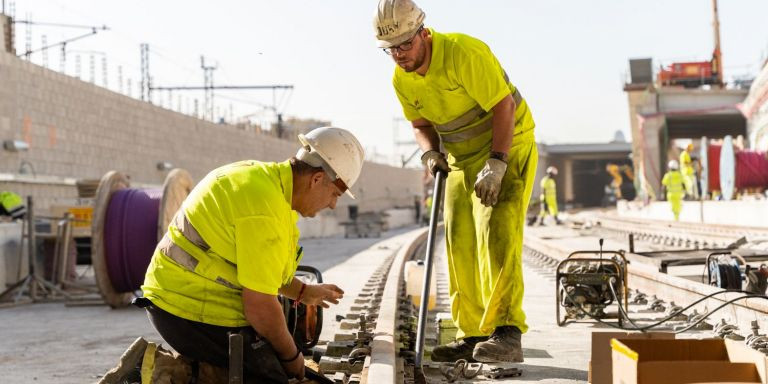 Dos obreros trabajan sobre una de las vías de Rodalies de Sant Andreu / LUIS MIGUEL AÑÓN