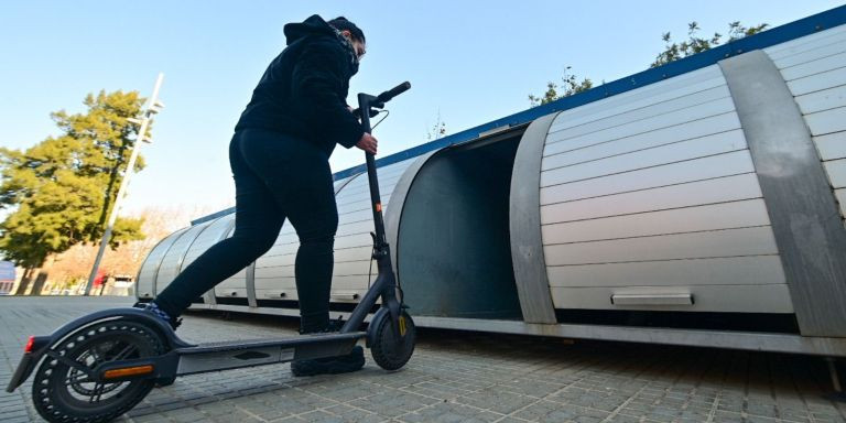 Una usuaria guardando su patinete en el Bicibox