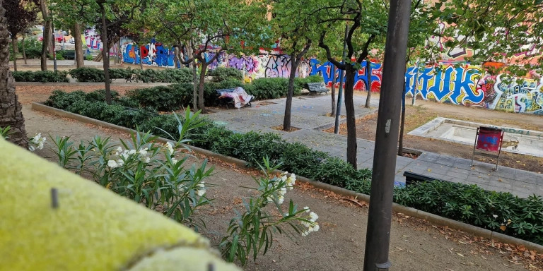 Una persona sin hogar durmiendo en los jardines de Walter Benjamin de Barcelona / CEDIDA