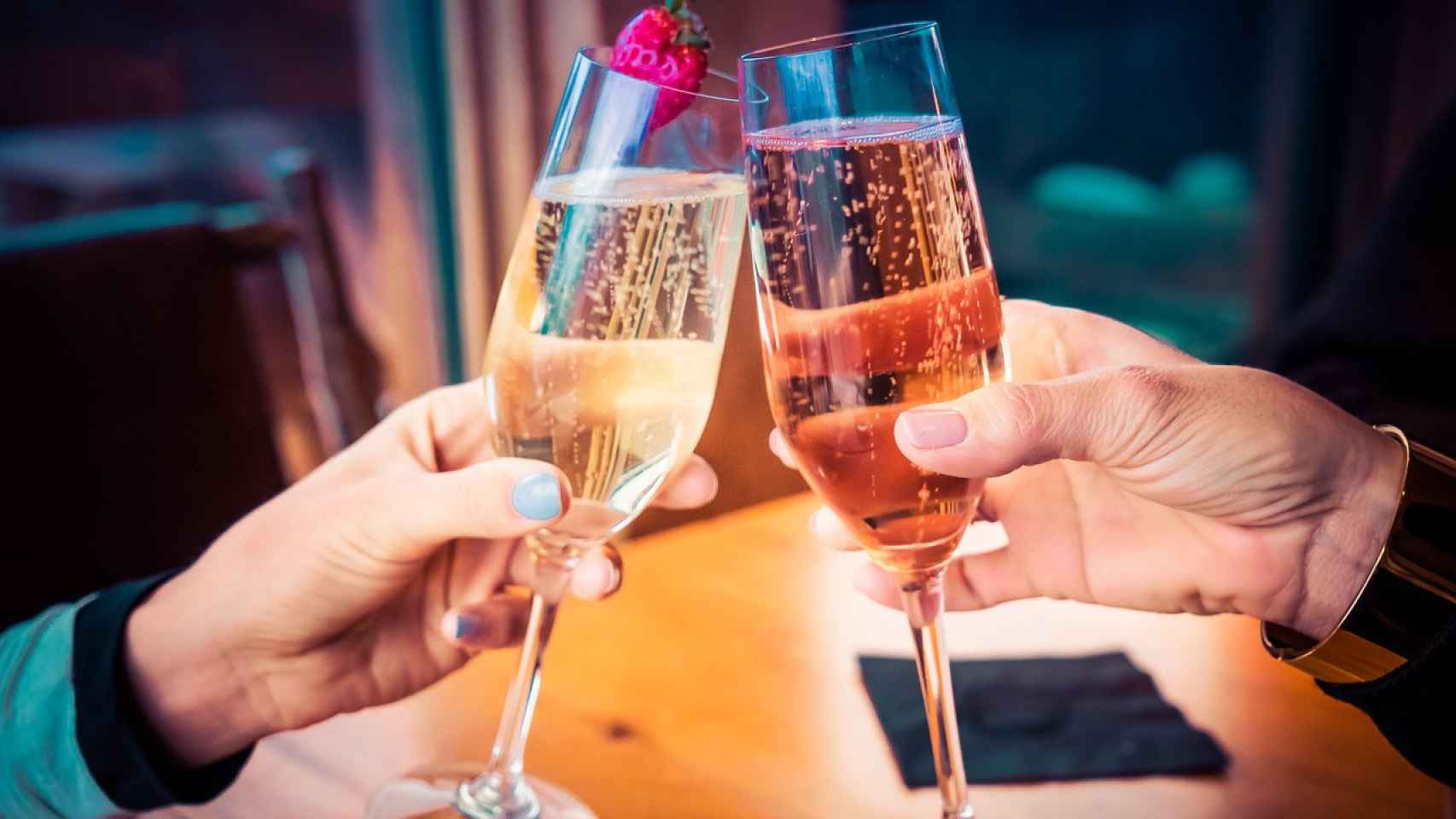 Dos personas brindando con copas de cava en una imagen de archivo