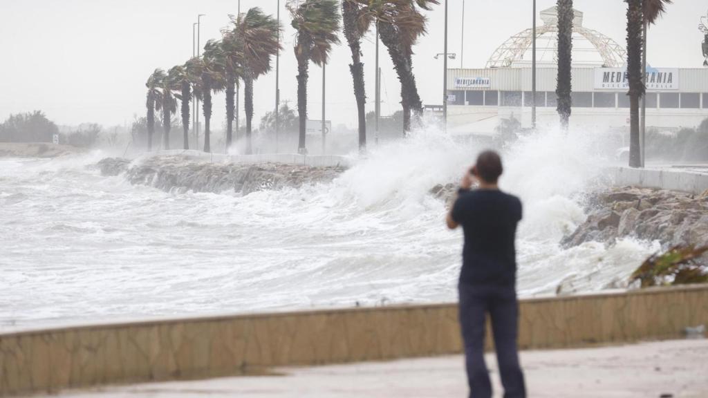 Un transeúnte en la playa de Barcelona este miércoles, 30 de octubre, durante el temporal