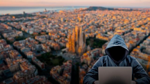 Fotomontaje de un hacker con Barcelona de fondo